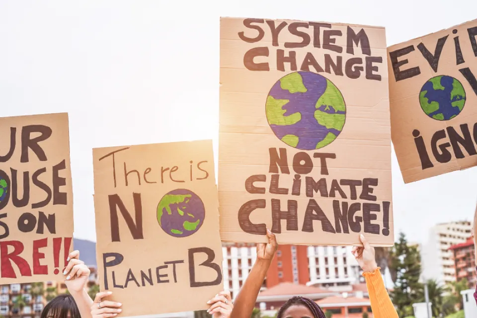 Close-up of signs being held up at climate change protest
